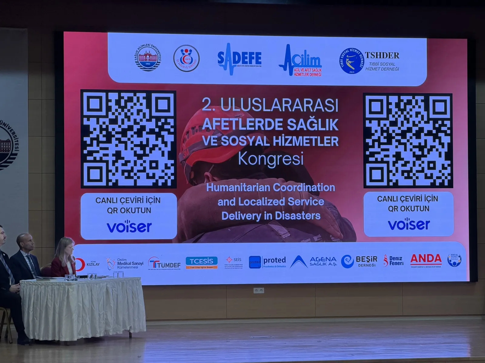 Kongre sahnesinde canlı çeviri için karekod gösteren ekran